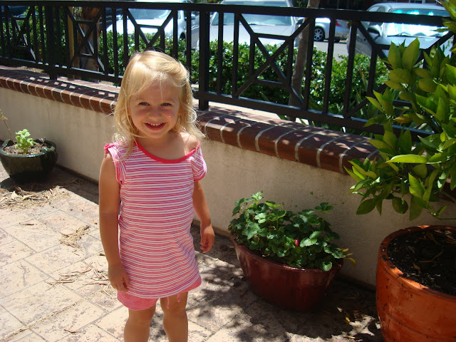 Young girl standing by Strawberry Plant