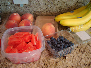 Peaches, watermelon, blueberries and bananas on countertop