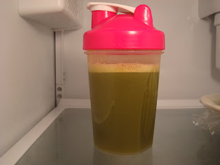 Shaker bottle in refrigerator filled with juice