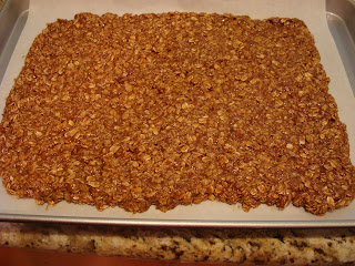 Homemade granola spread on parchment paper lined baking sheet