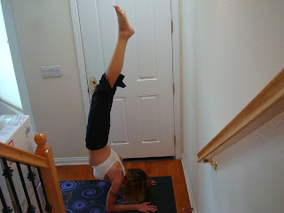 Woman doing Pincha Mayurasana yoga pose - 23