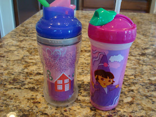 Children's sippy cups full of banana almond agave smoothies