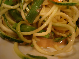Zuke Noodles tossed with asparagus, carrots, and cumbers topped with peanut sauce