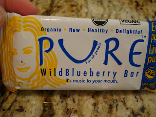 Hand holding Pure Wild Blueberry Bar