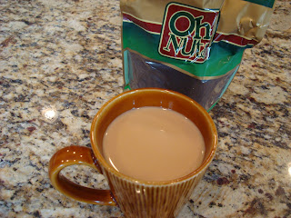 Mug full of French Roast Coffee on countertop with package in background