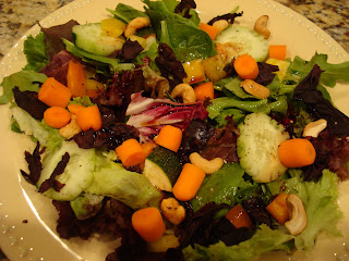 Greens salad with chopped vegetables cashews balsamic and olive oil