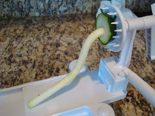 Center off spiralized zucchini attached to spiralizer