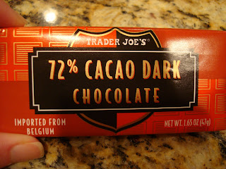 Hand holding Trader Joe's 72% Cacao Dark Chocolate Bar