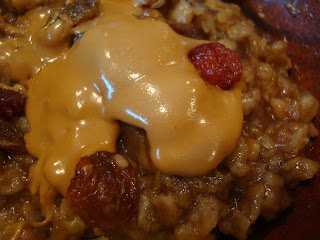 Close up of Banana Oatmeal topped with Sunflower Seed Butter and Raisins