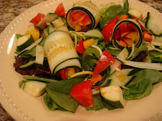 Raw Cucumber Wraps on top of greens and mixed vegetables