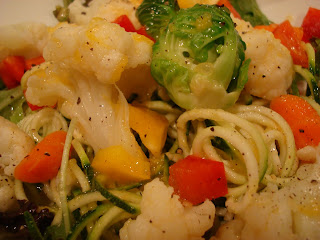 Close up of Spiralized zucchini noodles topped with mixed vegetables and dressing - 7