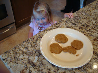Young girl smiling next to Maple & Flax "Peanut Butter" Pancake-Cookies on countertop