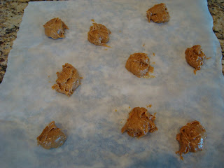 Raw Vegan Peanut Butter Cookie Dough batter in mounds on parchment paper