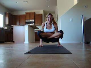 Woman doing Tolasana yoga pose