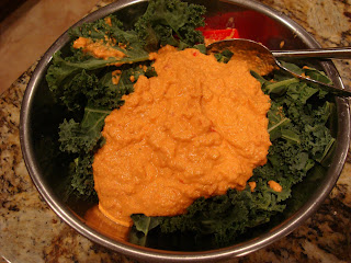 Kale in bowl with blended mixture poured over top