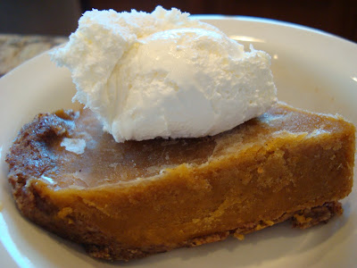 Side view of No-Bake Vegan Gluten Free Pumpkin Pie in white dish with whipped cream