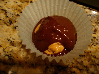 Remaining chocolate spooned over peanut butter mixture in paper liners