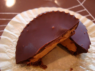 Stacked Raw Vegan Peanut Butter Cups on paper liner showing inside filling