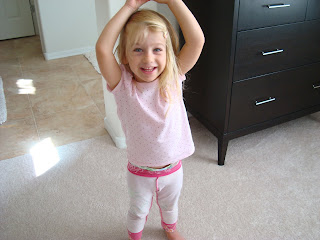 Young girl smiling with hands over head