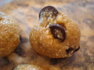 Up close of one Raw Vegan Chocolate Chip Cookie Dough Ball showing chocolate chips
