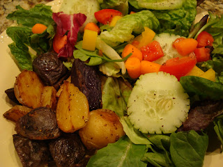 Mixed green salad with vegetables served with tri colored potatoes