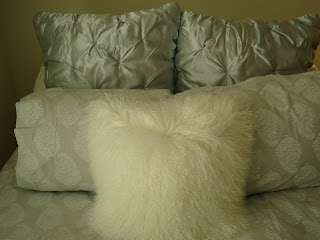 Pillows on bed with white fluffy pillow in front - 13