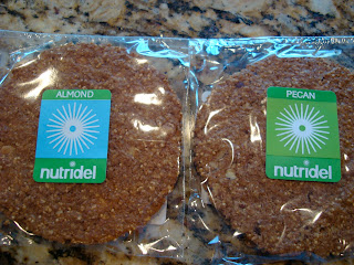 Two Nutridel cookies one almond one pecan flavor