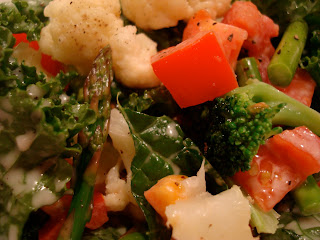Kale salad topped with mixed vegetables up close