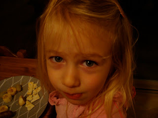 Close up of young girl eating snacks off of plate - 7