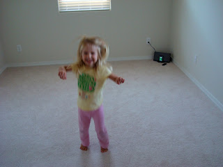 Young girl dancing to music in room