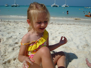 Young girl on beach playing in sand