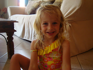 Young girl sitting in room in swimsuit on floor