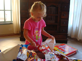 Young girl unwrapping presents