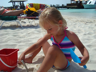 Young girl on beach building sand castle - 53