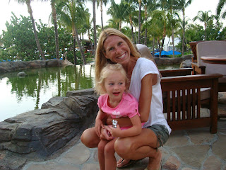 Woman and child at hotel smiling in front of water feature