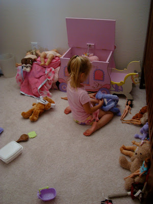 Backside of young girl playing with toys