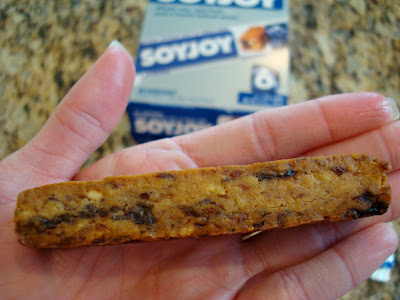 Hand holding one SoyJoy Bar