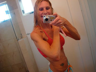 Woman flexing in front of mirror