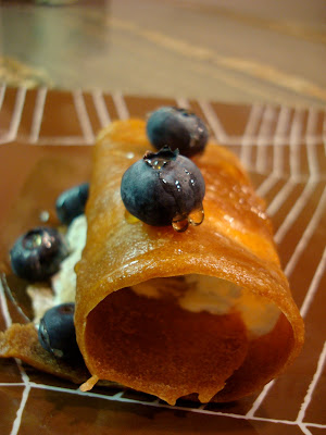 Banana Roll up with peanut butter topped with blueberries and maple syrup