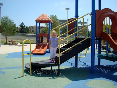 Young girl on playground equipment 