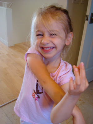 Child crossing arms and smiling