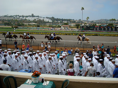 Military men lined up in front of track