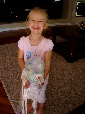 Young girl on pony smiling