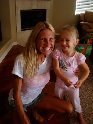 Woman squatting and child on her knee smiling