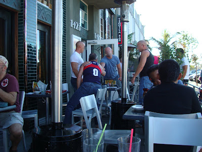 Outdoor seating at restaurant with people outside