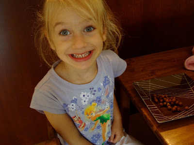 Young girl smiling eating at table