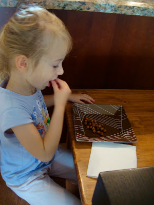 Young girl eating a plate of Carmelized Cinnamon Sugar Roasted Chickpea Peanuts