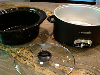 Crock Pot on counter top with stoneware removed and lid in front of it