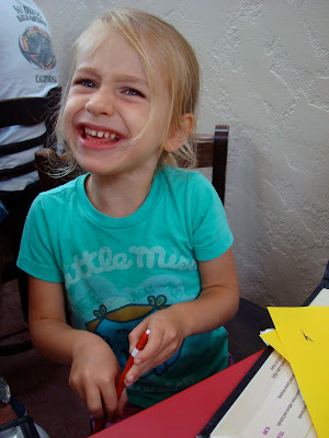 Young girl sitting I chair smiling holding pen - 15