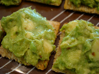 Two crackers spread with Homemade Guacamole 